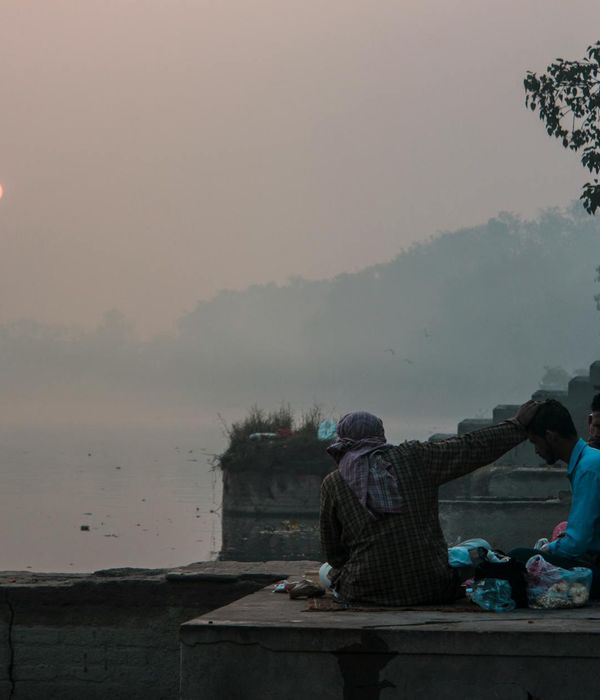 Person meditating peacefully in a serene natural environment with icy light.